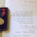 Imperial Service Medal and letter of commendation received in 1957 by Charlie Seaman, former Air Raid Precautions (ARP) warden in Stanhoe, for his part in the rescue of crew members of a Wellington bomber which crashed near Stanhoe Hall in 1943.