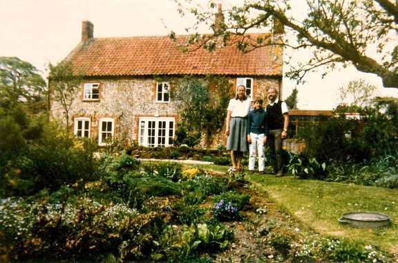 Gillian and Ken Beckett and their son in the garden of Bramley Cottage