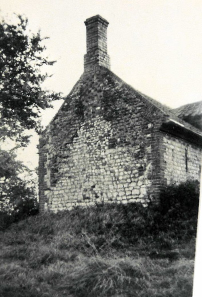 A chalk and brick cottage on the east side of the Pit.