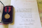 Imperial Service Medal and letter of commendation received in 1957 by Charlie Seaman, former Air Raid Precautions (ARP) warden in Stanhoe, for his part in the rescue of crew members of a Wellington bomber which crashed near Stanhoe Hall in 1943.