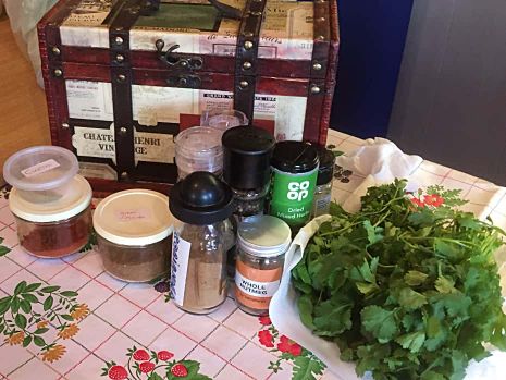 Spices and fresh coriander on a Christmas tablecloth