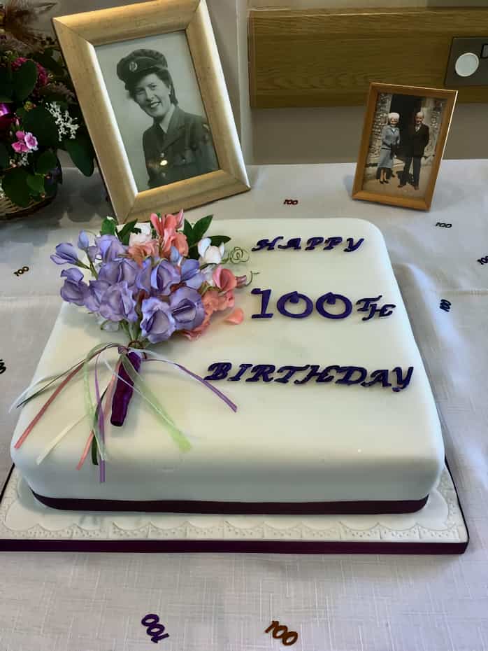 Birthday cake with flower posy and photos